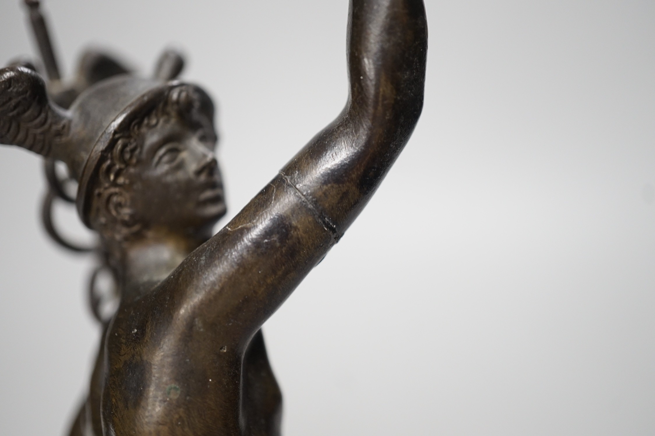 A bronze figure of Mercury on a graduated marble plinth. 33cm tall